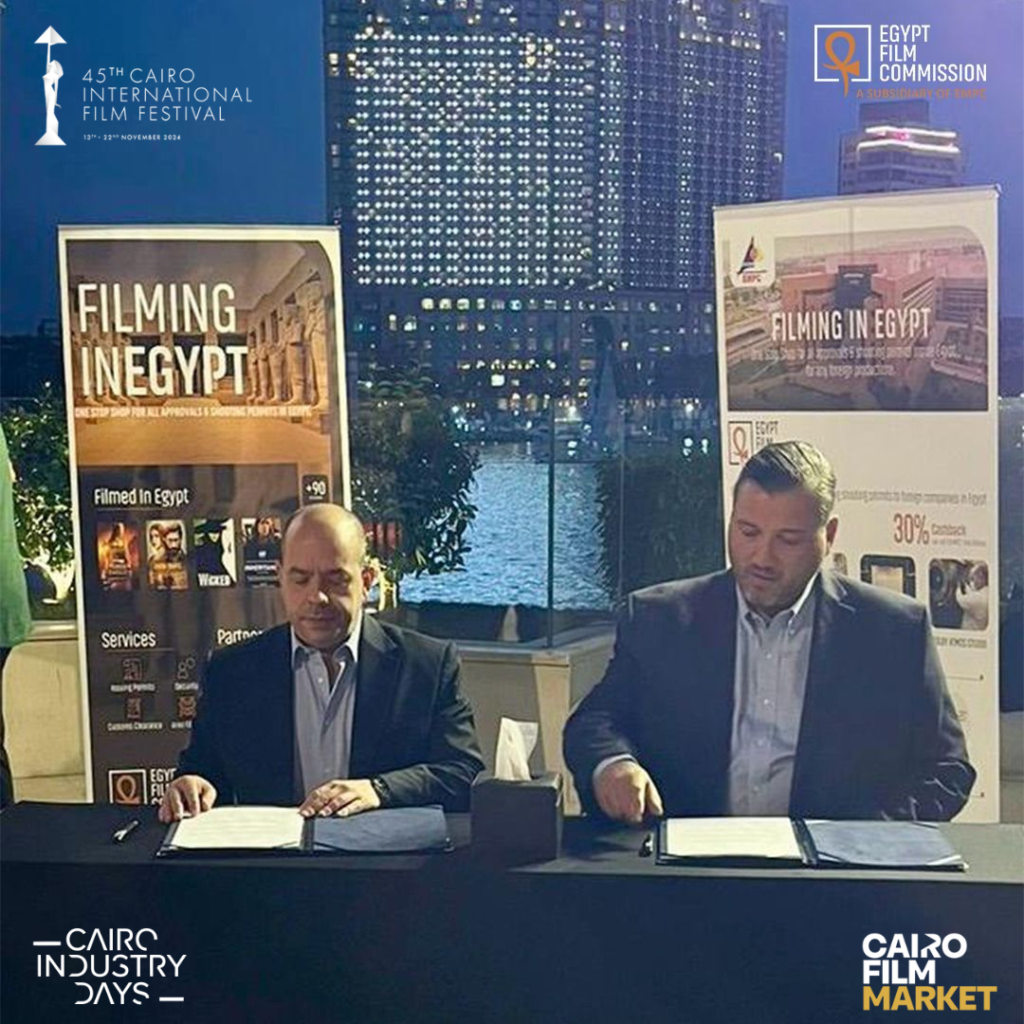 Ahmed Badawy and John Rakich signing a collaboration protocol at the Cairo International Film Festival 2024